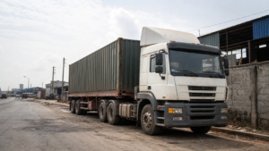 Used tractor-trailer parked in a Nigerian logistics yard for a guide to starting a trucking business in Nigeria