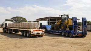 Flatbed and drop deck trailer comparison in an African logistics yard